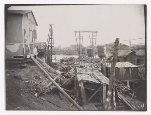 Construction of the Paris Metro, exterior view with debrise and wires with the Seine in the background,  Paris, France