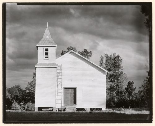 White wooden church with bell tower and ladder