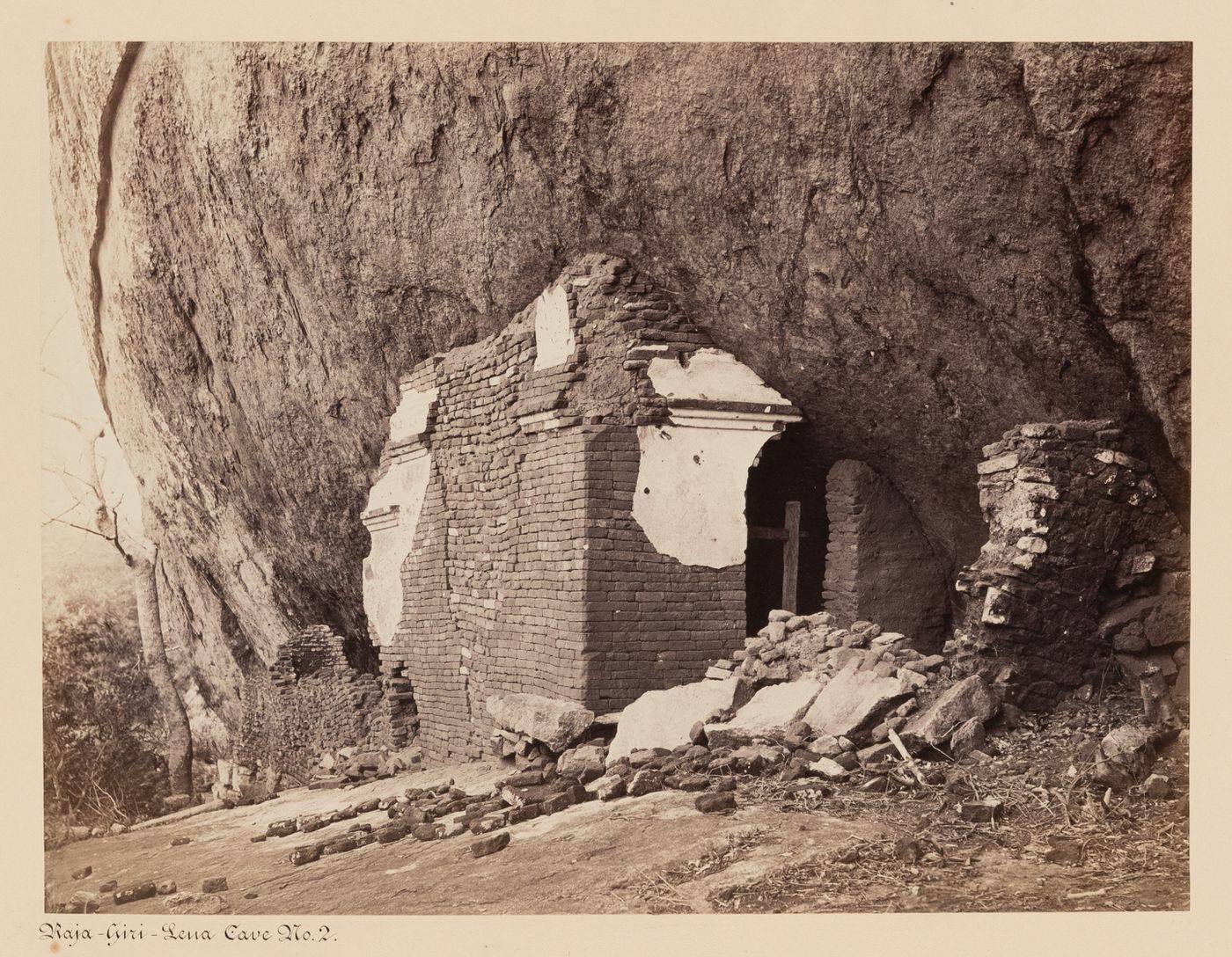 View of the ruins of a brick building, possibly known as Cave No. 2, Raja-Giri-Lena (also known as Raja-Giri-Lena-Kande and Care Mountain), Mihintale, Ceylon (now Sri Lanka)