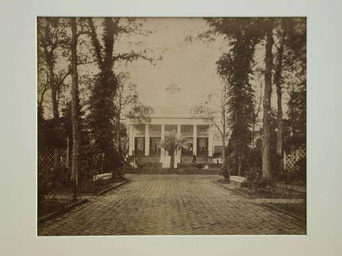 View of the drive and front façade of a mansion built in southern plantation style
