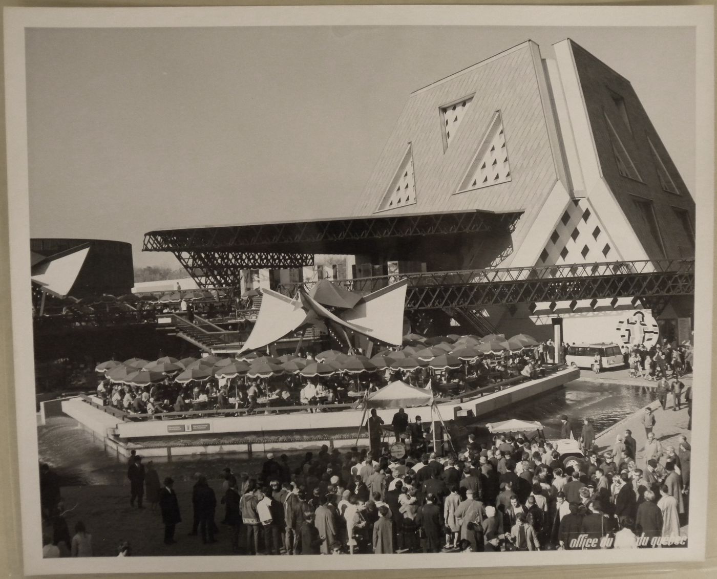View of a terrace and of a music band at the Plaza of the Universe near the Man the Explorer Pavilion, Expo 67, Montréal, Québec