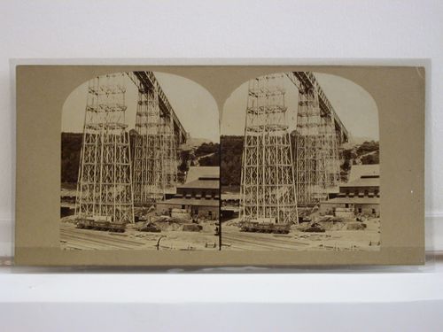 Stereograph of the Crumlin Viaduct from below showing a building site or a railway yard, Monmouthshire (now in Gwent County), Wales