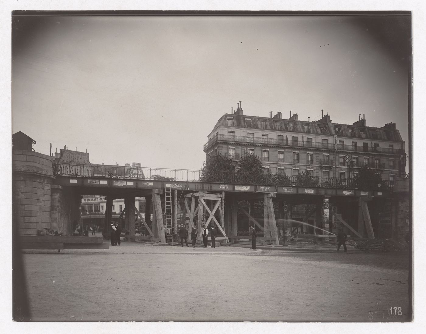 Construction of the Paris Metro, exterior view with raised bridge and workers, Paris, France