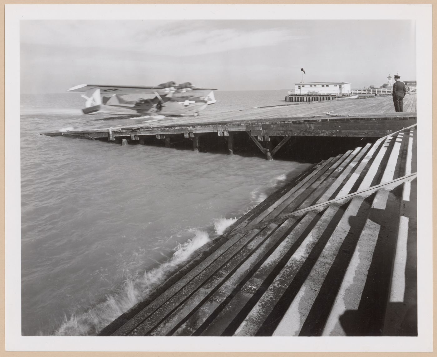 View of the Seaplane Ramp and Boathouse showing a plane landing, Consolidated Aircraft Corporation Assembly Plant, New Orleans, Louisiana