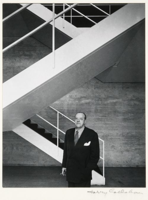 Portrait of Ludwig Mies van der Rohe standing in stairwell of the Arts Club of Chicago, Illinois
