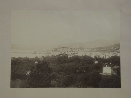Distant view of a city on a bay showing a church [?] and other buildings, France [?]