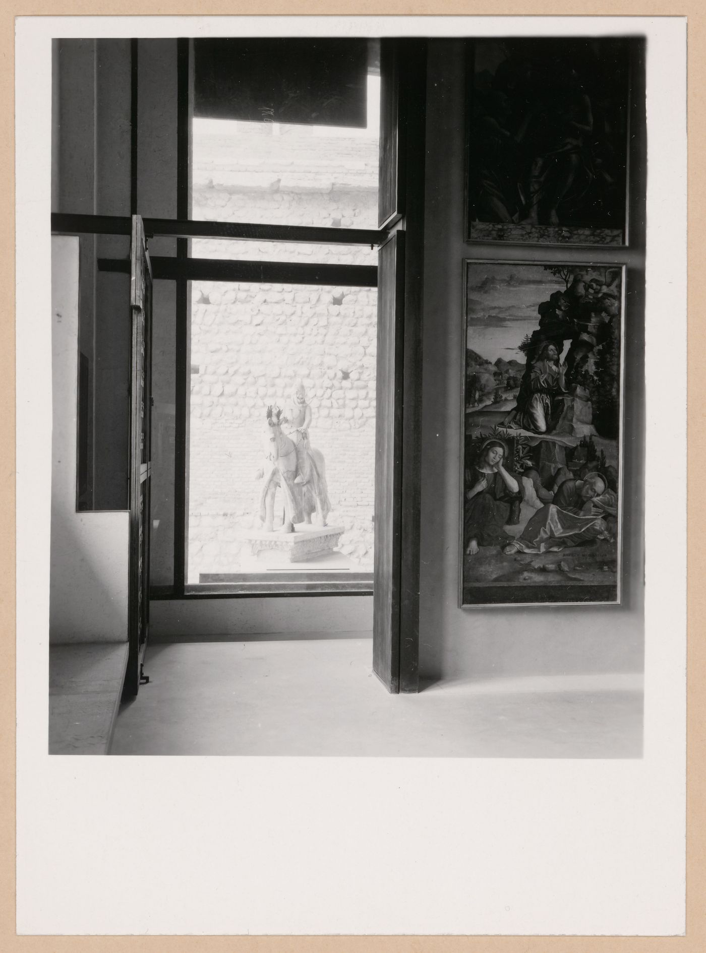 Interior view of a gallery showing paintings with the Can Grande della Scala Statue in the background, Museo di Castelvecchio, Verona, Italy