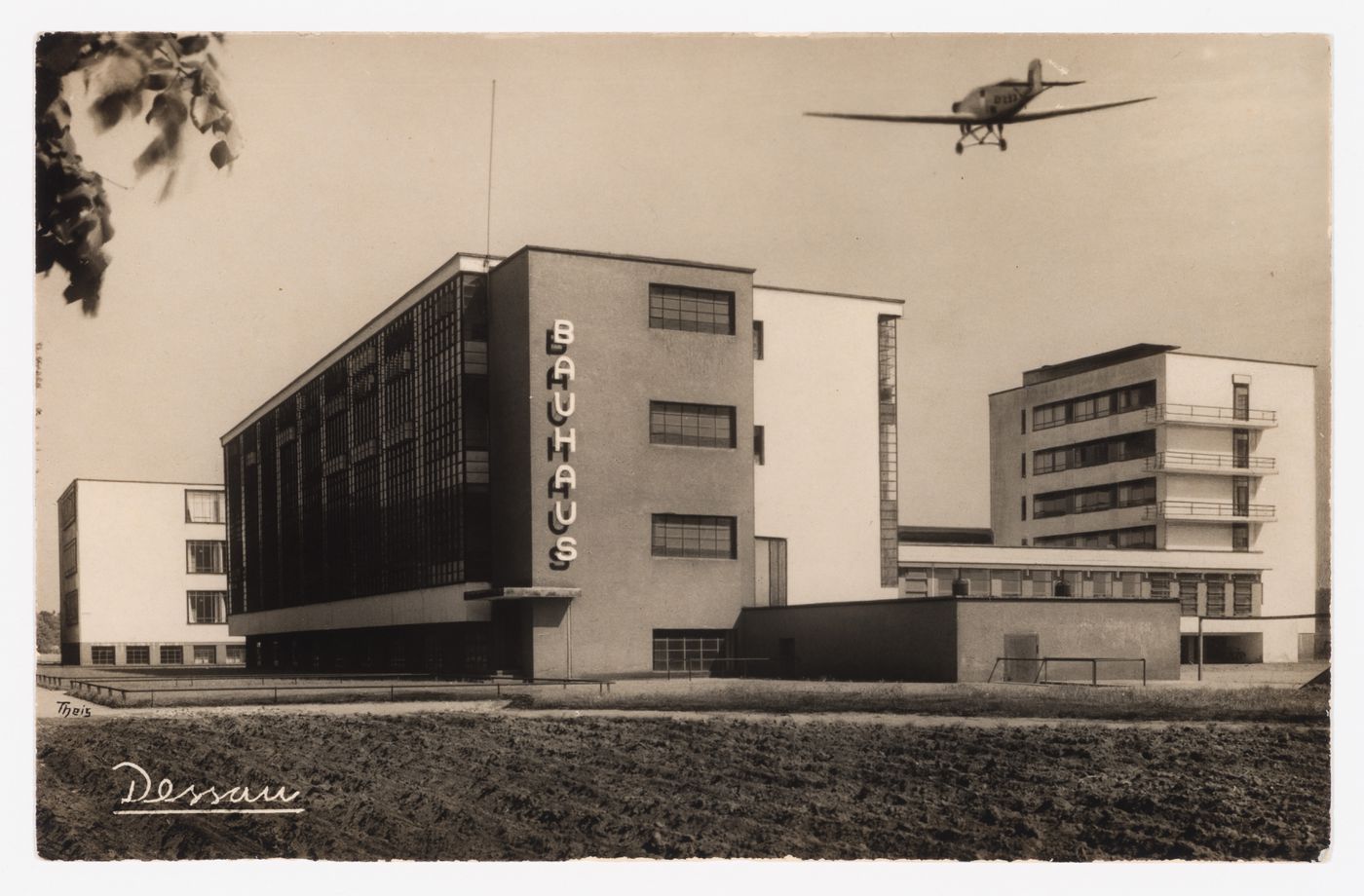 Exterior view of the Bauhaus building with a low-flying plane above, Dessau, Germany