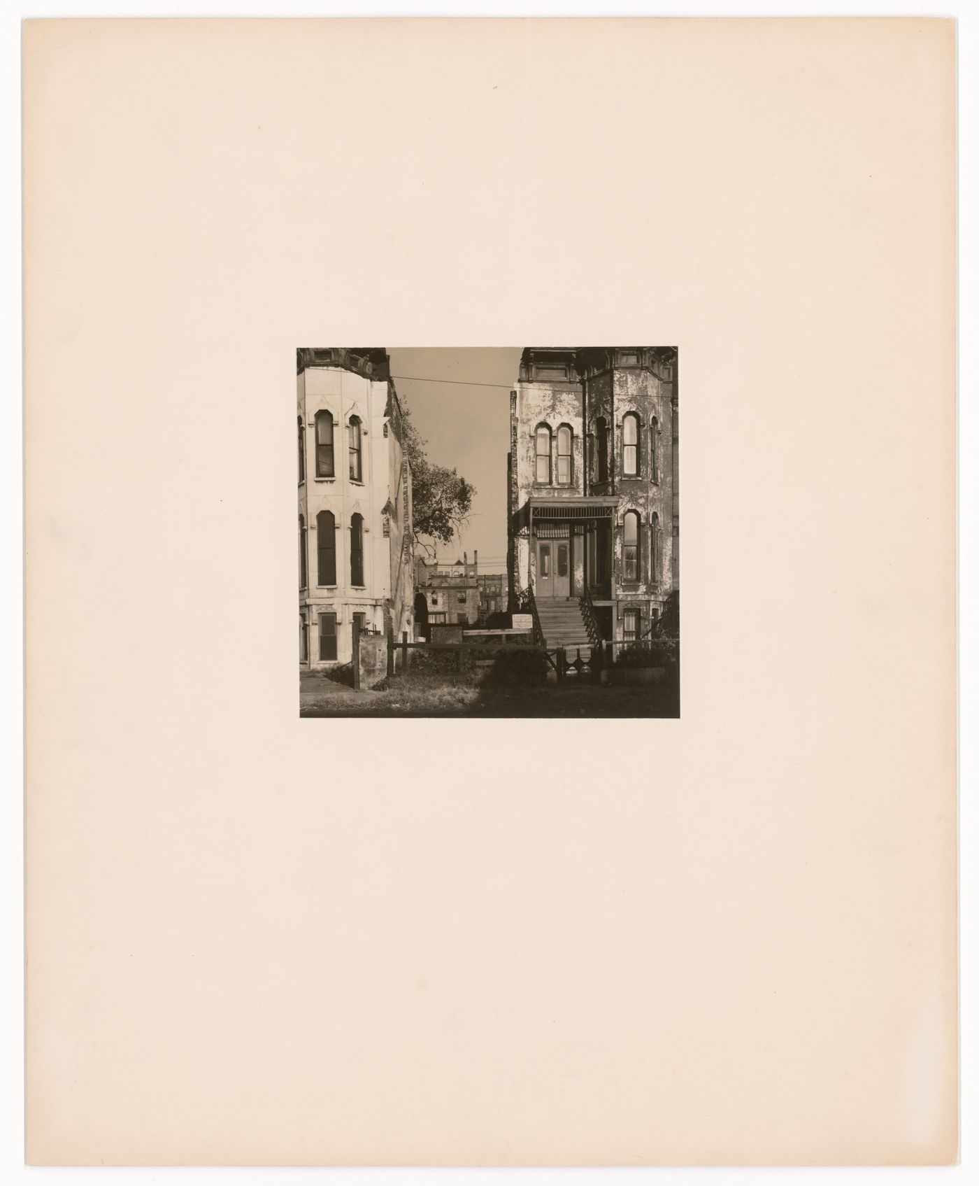 Two Victorian slum buildings, front view with fence between them, Chicago, Illinois, United States
