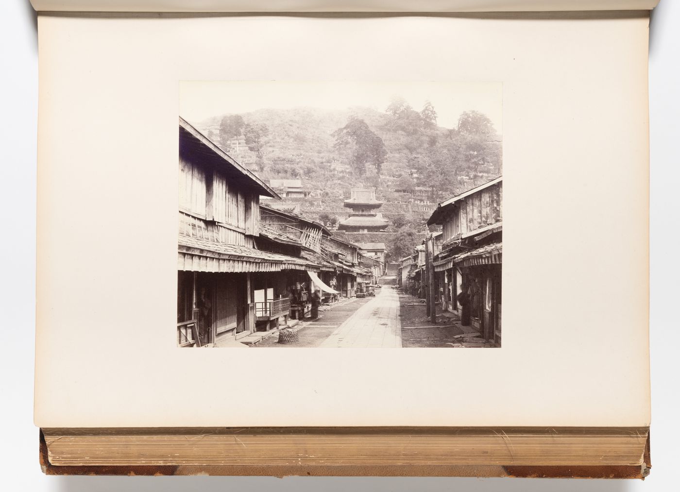 View of a street and the Kaisando (also known as the Founder's Hall) of the Kofukuji Temple complex showing a cemetery in the background, Nagasaki, Japan