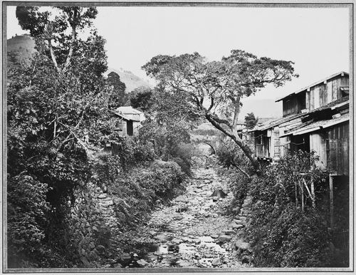 View of houses, a stone arch bridge and the Nakashima River, Nagasaki, Japan