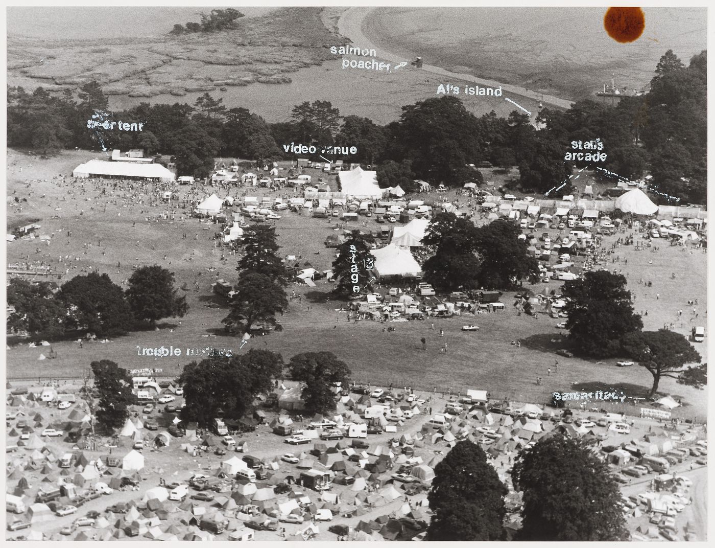 Aerial view of the Elephant Fayre festival in Port Eliot, England, showing beer tent, stage, "Stan's arcade", "Al's island", and video venue