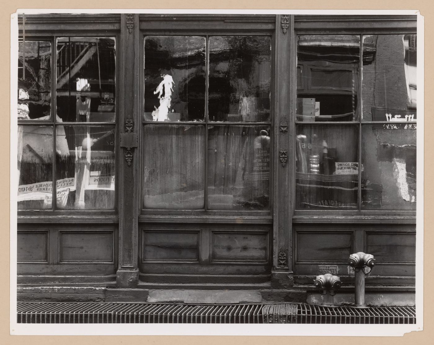Partial view of the ground floor of a commercial building showing window reflections, Lower Manhattan, New York City, United States,