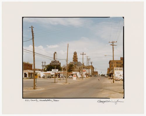 Distant view of the Ellis County Courthouse with a street, utility poles, signs and buildings in the foreground, Waxahachie, Texas, United States
