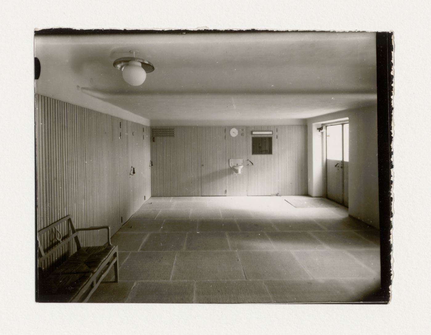 Interior view of the waiting room of the Chapel of the Holy Cross showing the entrance and drinking fountain, Woodland Crematorium and Cemetery, Stockholm