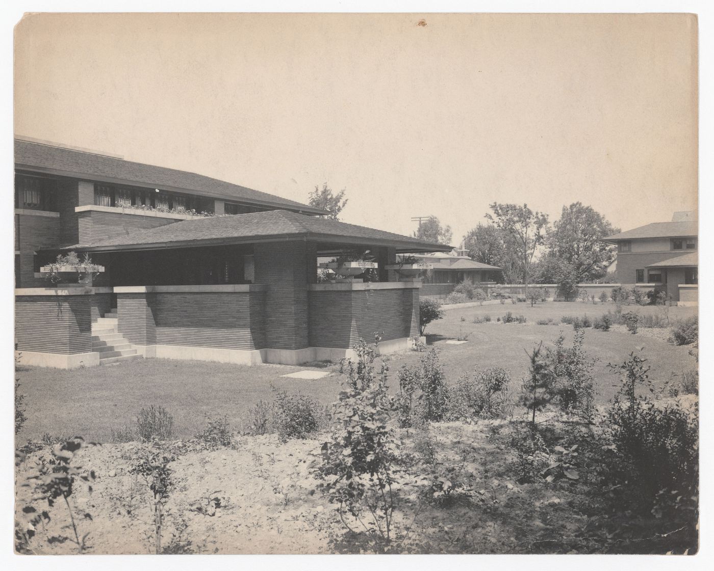View of Darwin D. Martin House from Summit Avenue showing the cast porch over the floricycle with Barton House on the right, Buffalo, New York