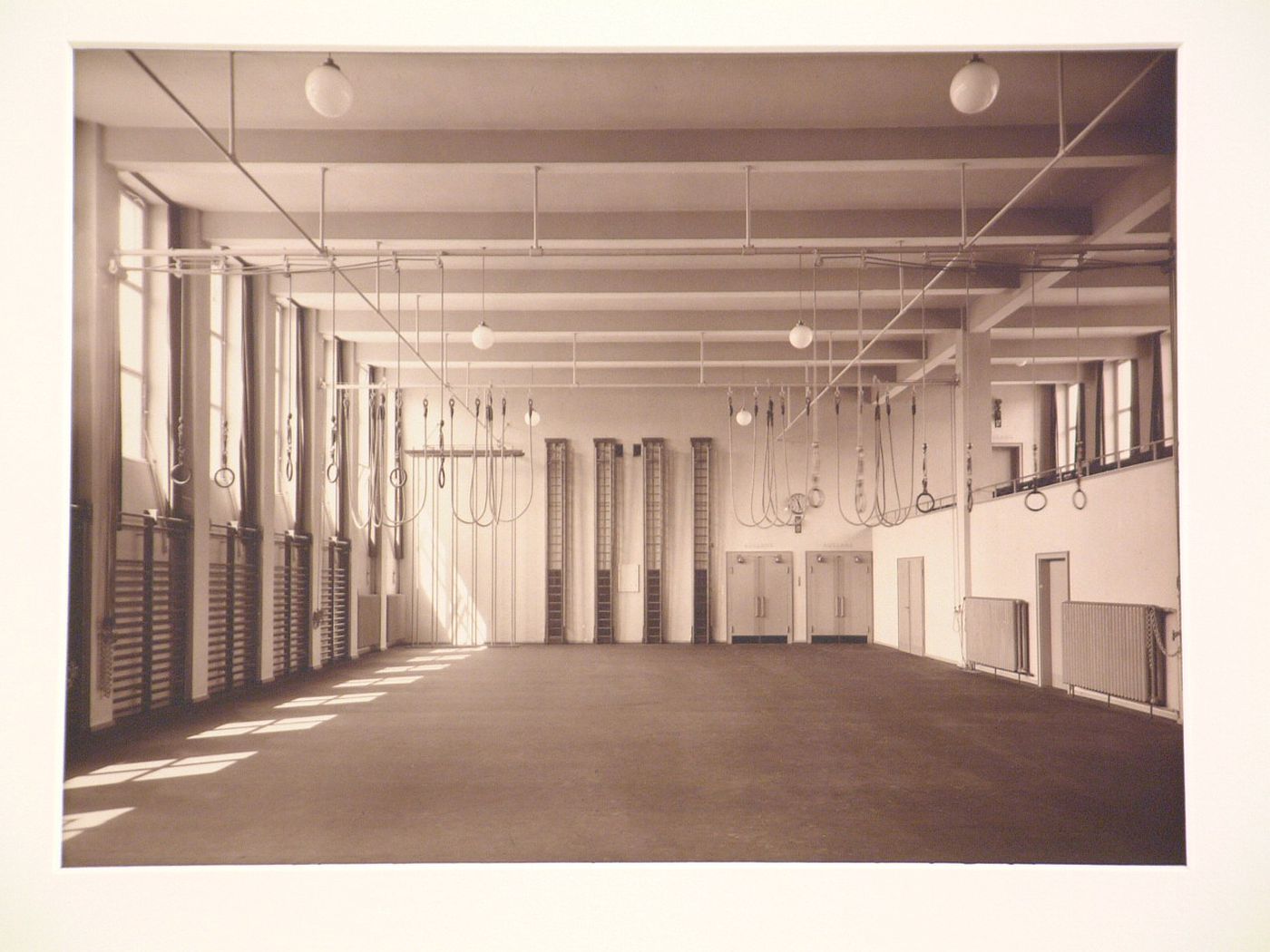Interior, view of school gymnasium with rings suspended from ceiling, Cologne, Germany
