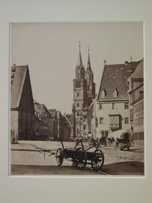 Church of Saint Lorenz, towers at west end, street and carts in foreground, Nuremberg, Germany