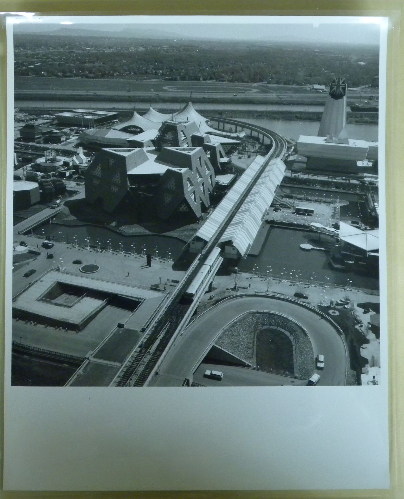 View of the Expo-Express station and of the Great Britain, Man the Producer and Australian Pavilions with Montréal as background, Expo 67, Montréal, Québec