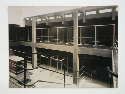 Interior view of inspections agency for electrical works, showing open two-storey space with stairs in foreground, Frankfurt am Main, Germany