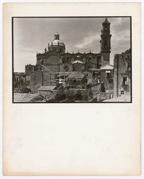 View of a façade of Santa Prisca showing the dome, the nave and a tower with houses in the foreground, Taxco de Alarcón, Mexico