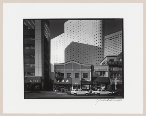 View of low-rise buildings and the Shinjuku Washington Hotel showing the Shinjuku NS Building in the background, Tokyo, Japan