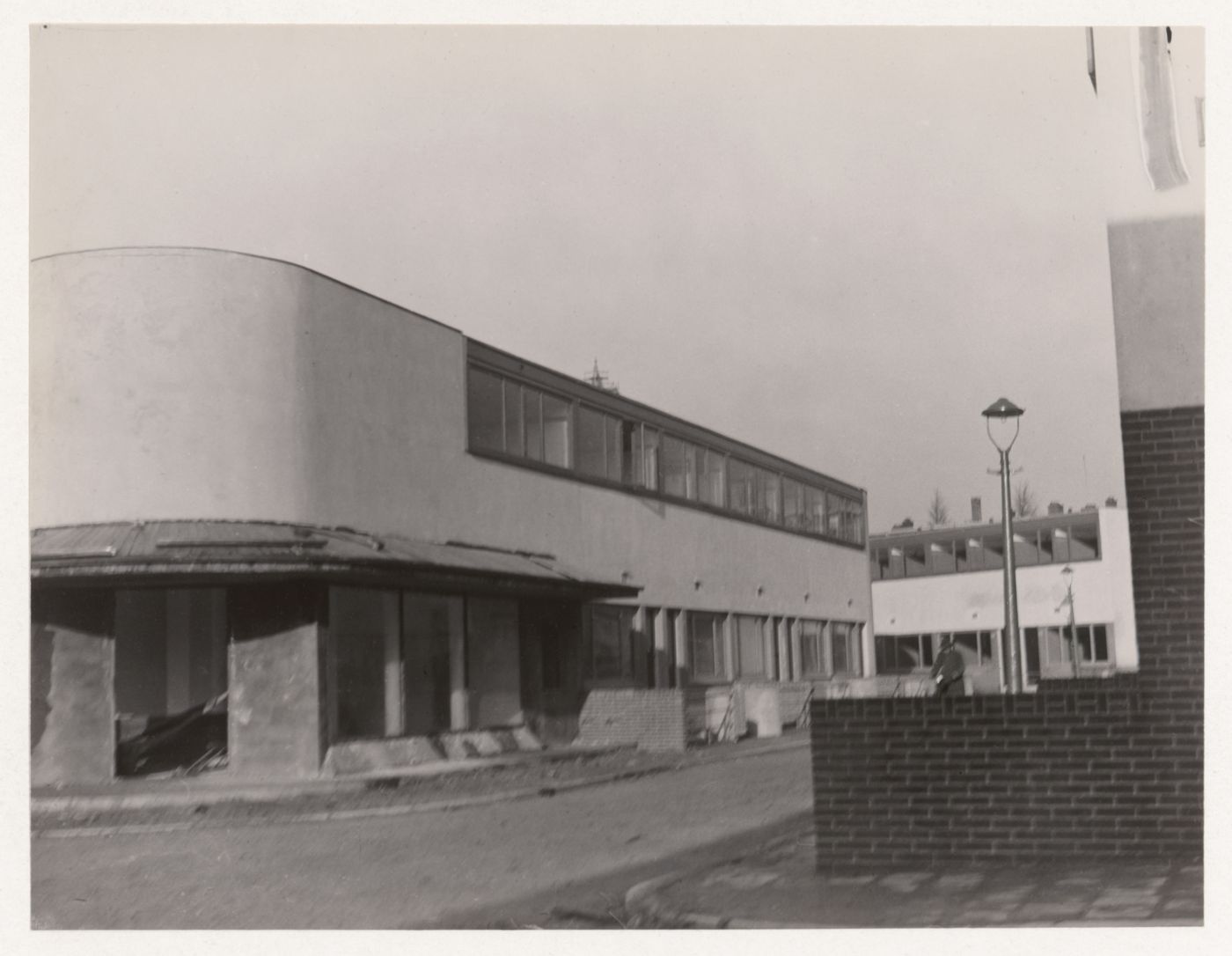 Exterior view of Kiefhoek Housing Estate showing a corner store under construction, Rotterdam, Netherlands