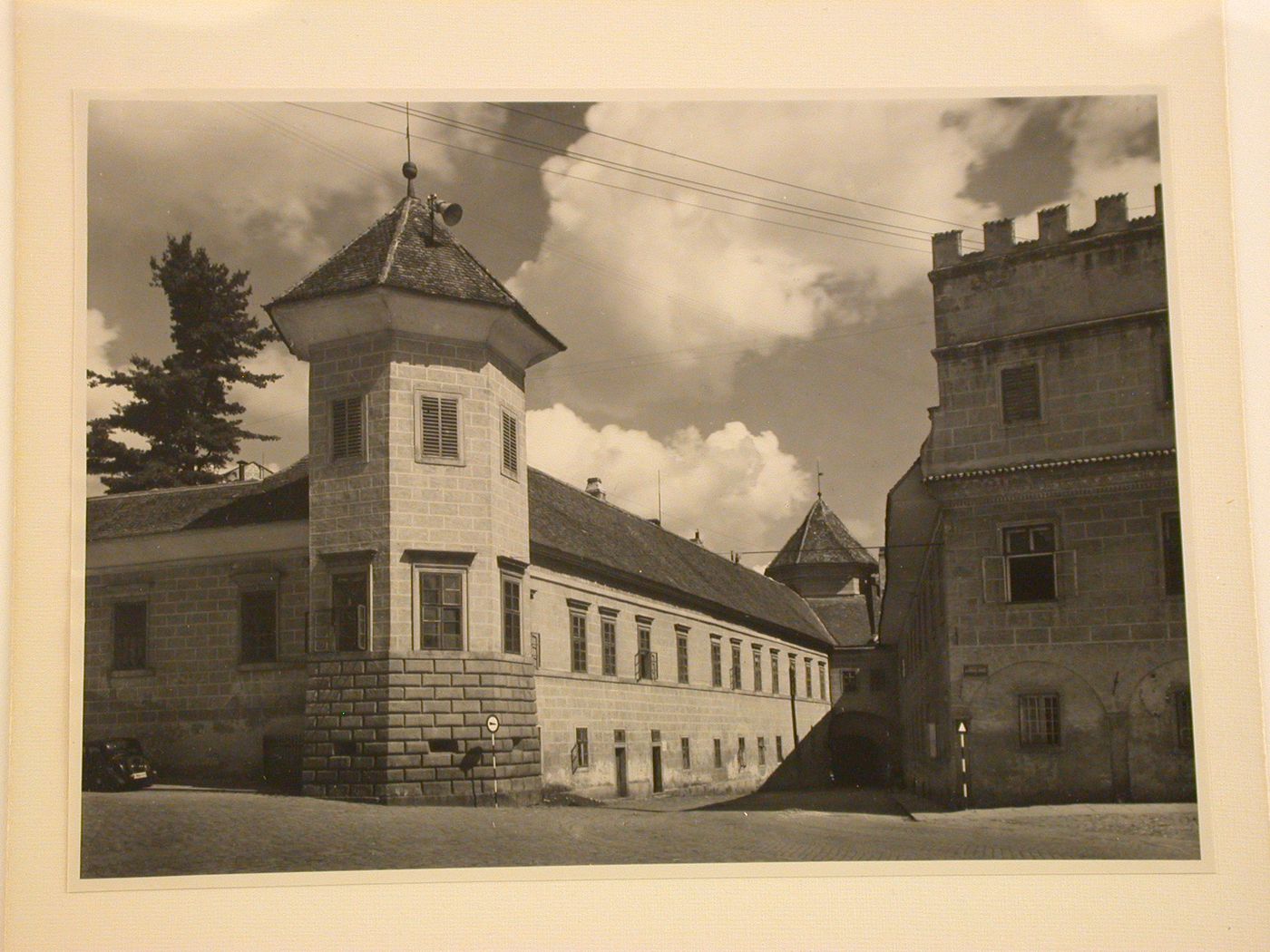 View looking down a street from the Námestí Míru [Town Square] and showing a wing (now the Art Gallery Jana Zrzavého) of Telc Château on the left, Telc, Czechoslovakia (now Czech Republic)