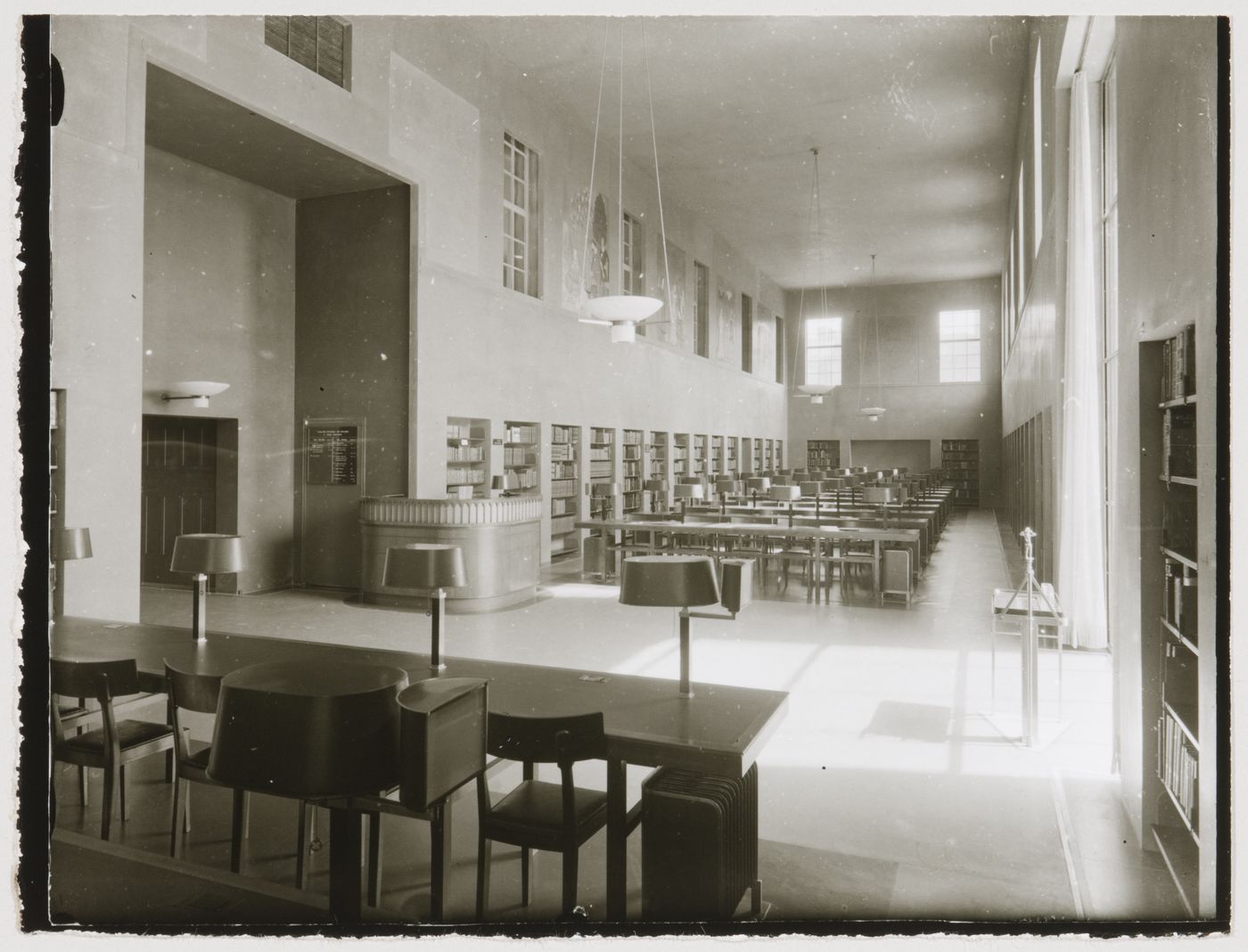 Interior view of the south reading room of Stockholm Public Library showing tables, chairs and bookshelves, 51-55 Odengatan, Stockholm