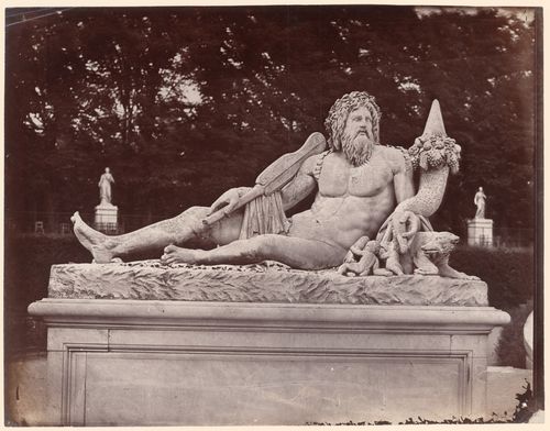 Tuileries Gardens, view of a reclining male god, carved in stone, Paris, France