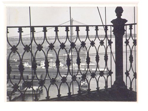 View of Manhattan Bridge and East River through iron grillwork, New York City, New York