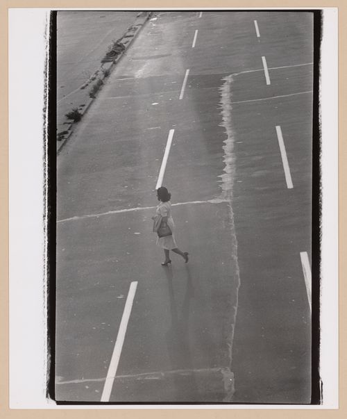 View of a woman walking across a highway, New York City [?], United States