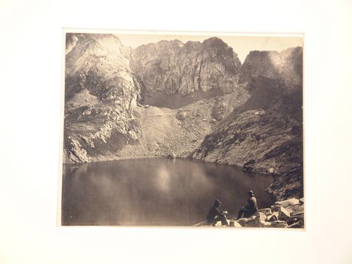 View of a lake in the mountains, with two seated figures, Luchon, France