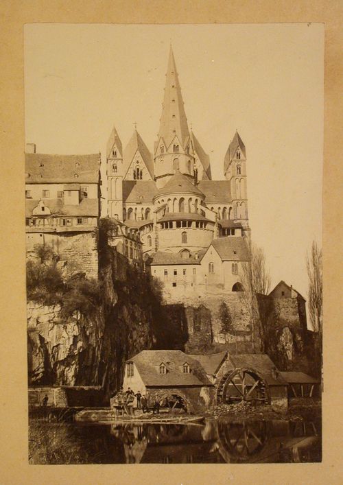View of the rear of the Limburger Dom taken from across a river showing waterwheels and surrounding buildings, Limburg an der Lahn, Germany