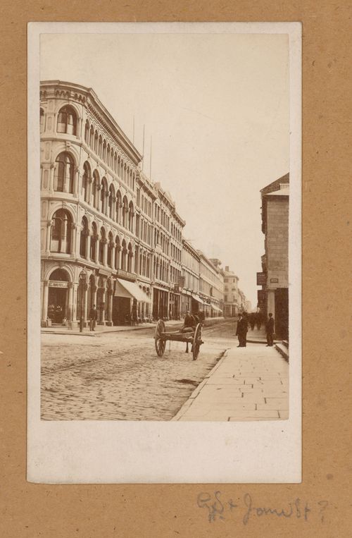 View of rue Saint-Jacques showing a horse-drawn vehicle and streetcar tracks, Montréal, Canada (now Montréal, Québec, Canada)
