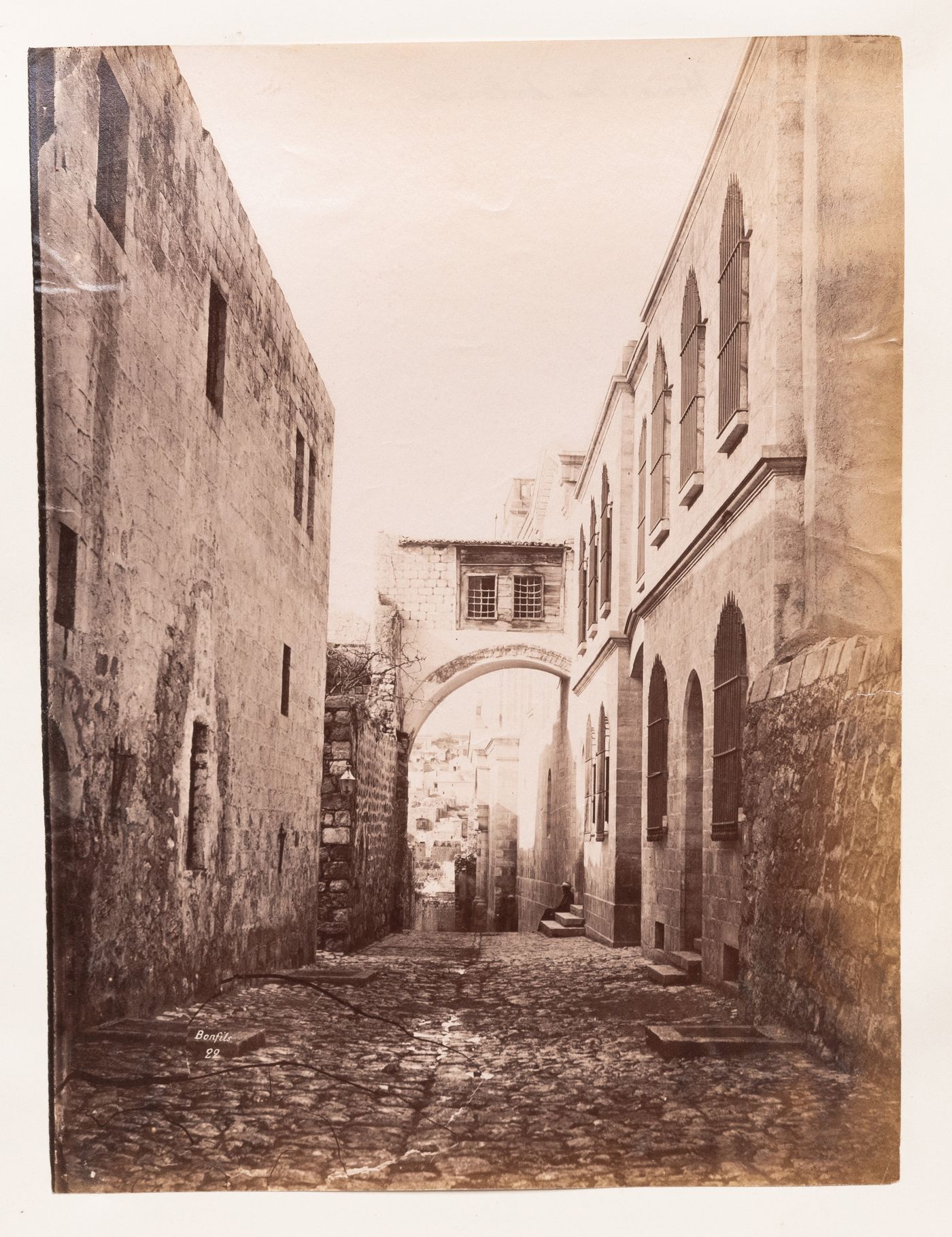 View of an alley between two buildings leading to an arch, Europe or Near East