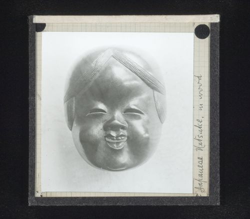 View of wood netsuke of human face, Japan