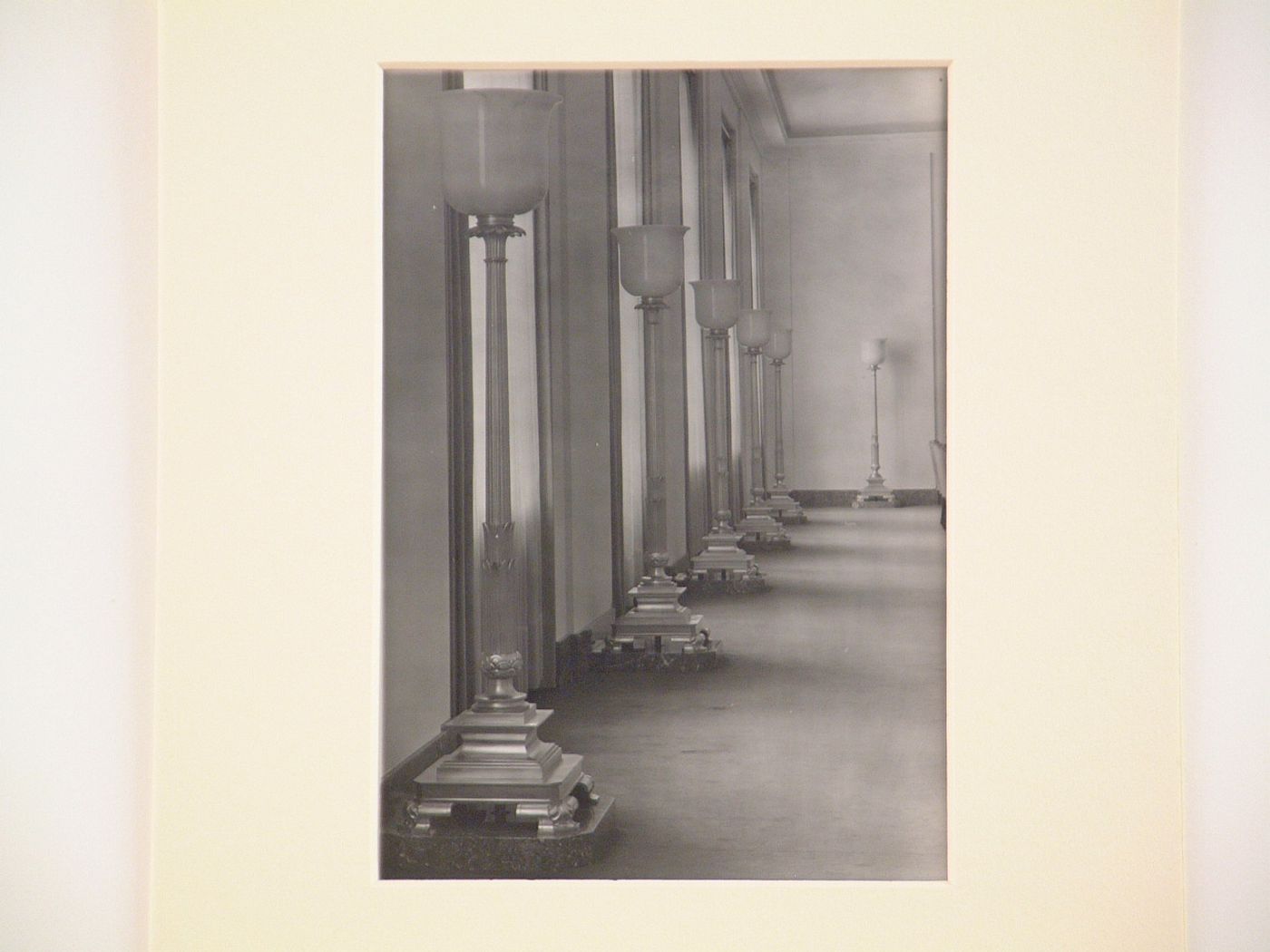 Interior, detail of hallway with many large floor-lamps near windows