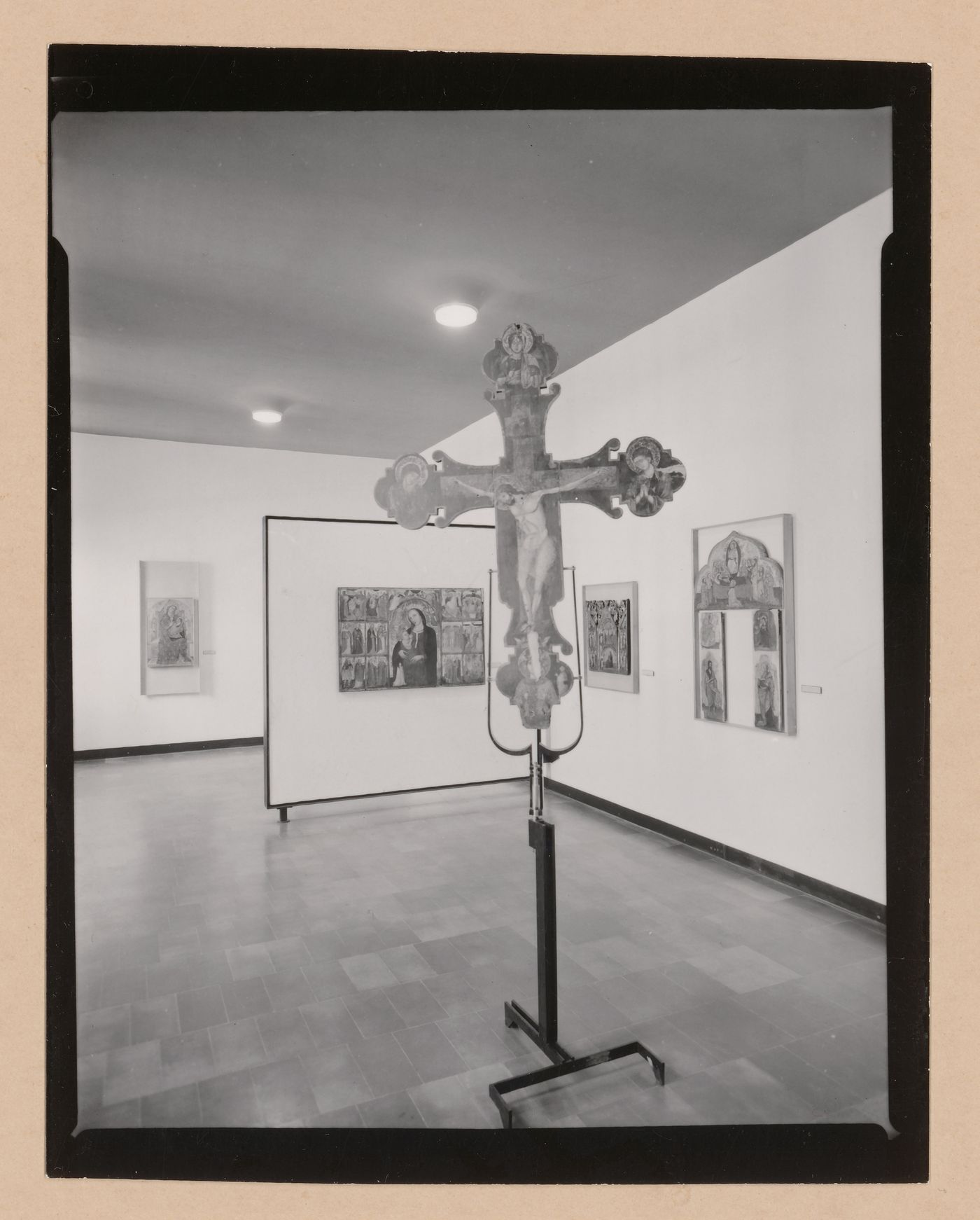 Interior view of a gallery showing a freestanding painted crucifix and paintings, Museo Correr, Venice, Italy