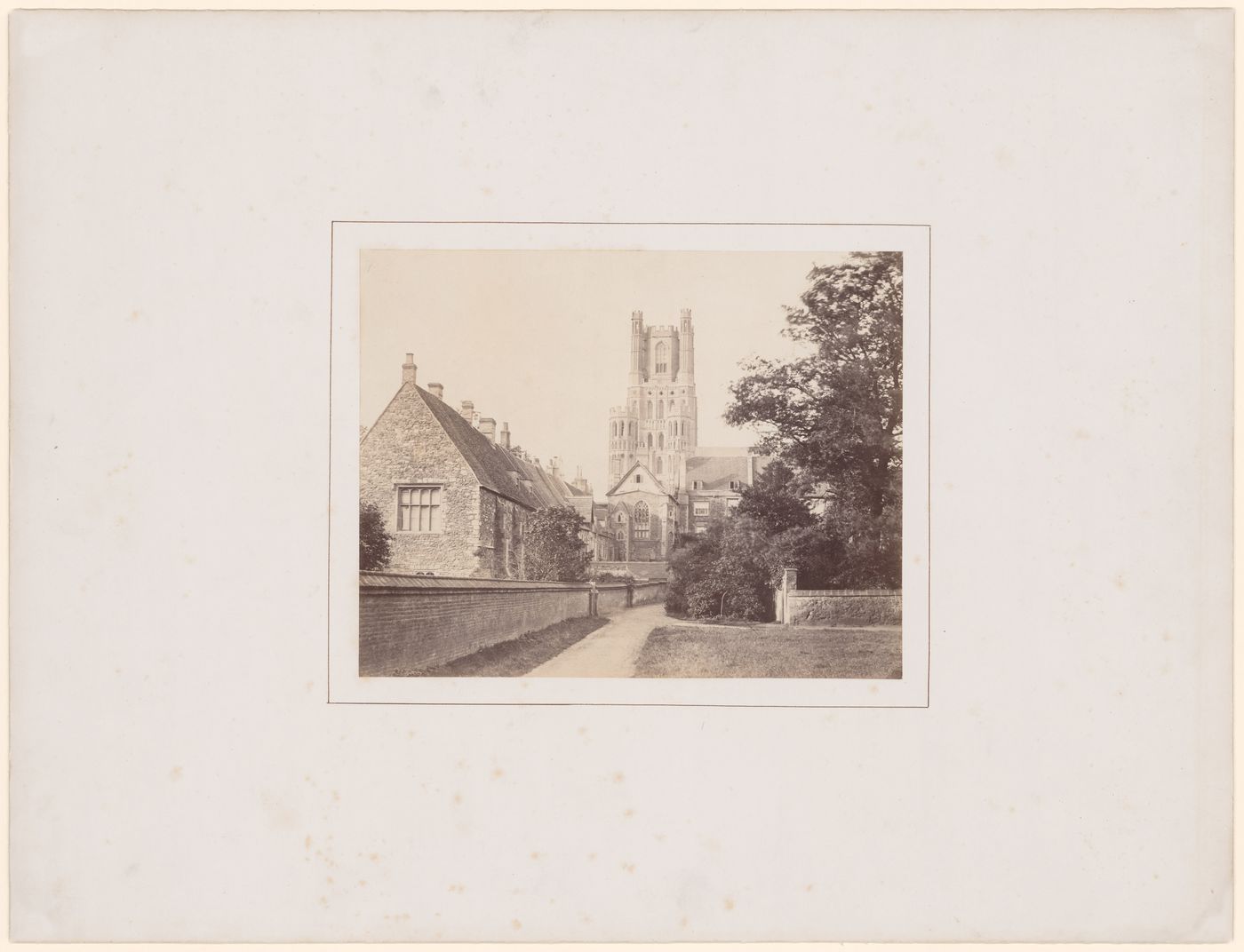 Distant view of Southwest transept tower of cathedral (from the South) with the Bishop's Palace in the foreground, at left, Ely, England