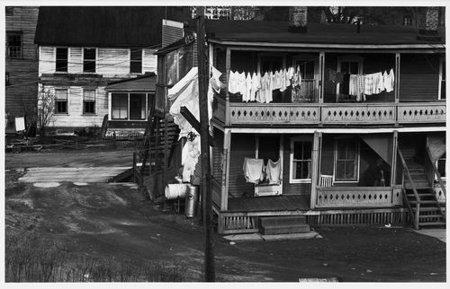 View of the rear façade of a house showing clothes hung on a clothes line with another house in the background, New Jersey