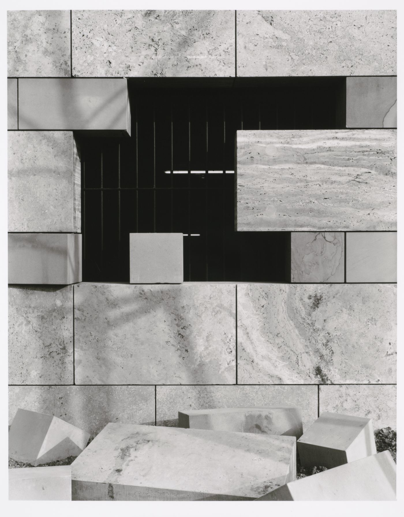 View of a barred window opening onto the parking garage of the Neue Staatsgalerie [New National Gallery] with cut stones in the foreground, Stuttgart, Germany