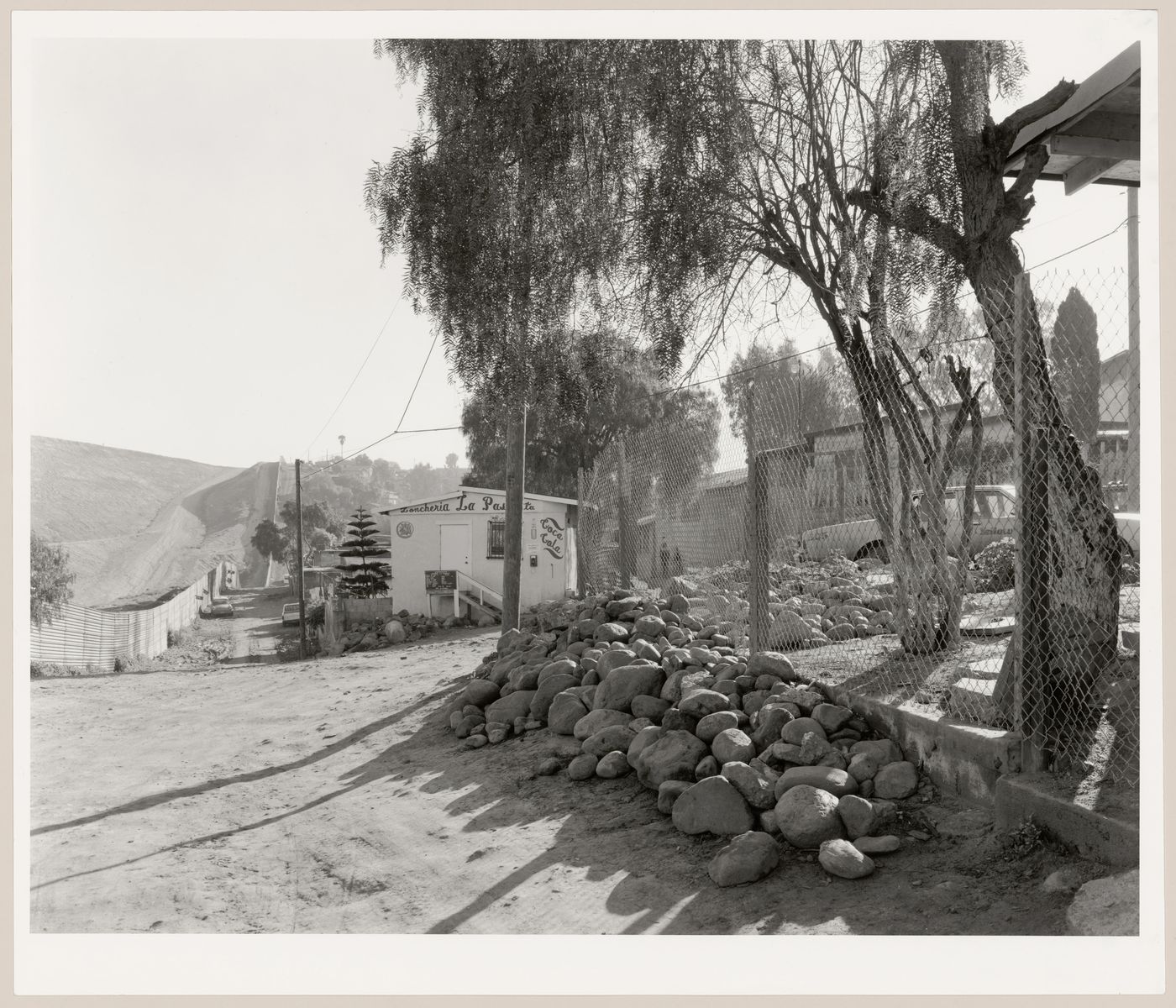 View of a restaurant with the Mexico-United States border fence on the left, Colonia Libertad, Tijuana, Mexico