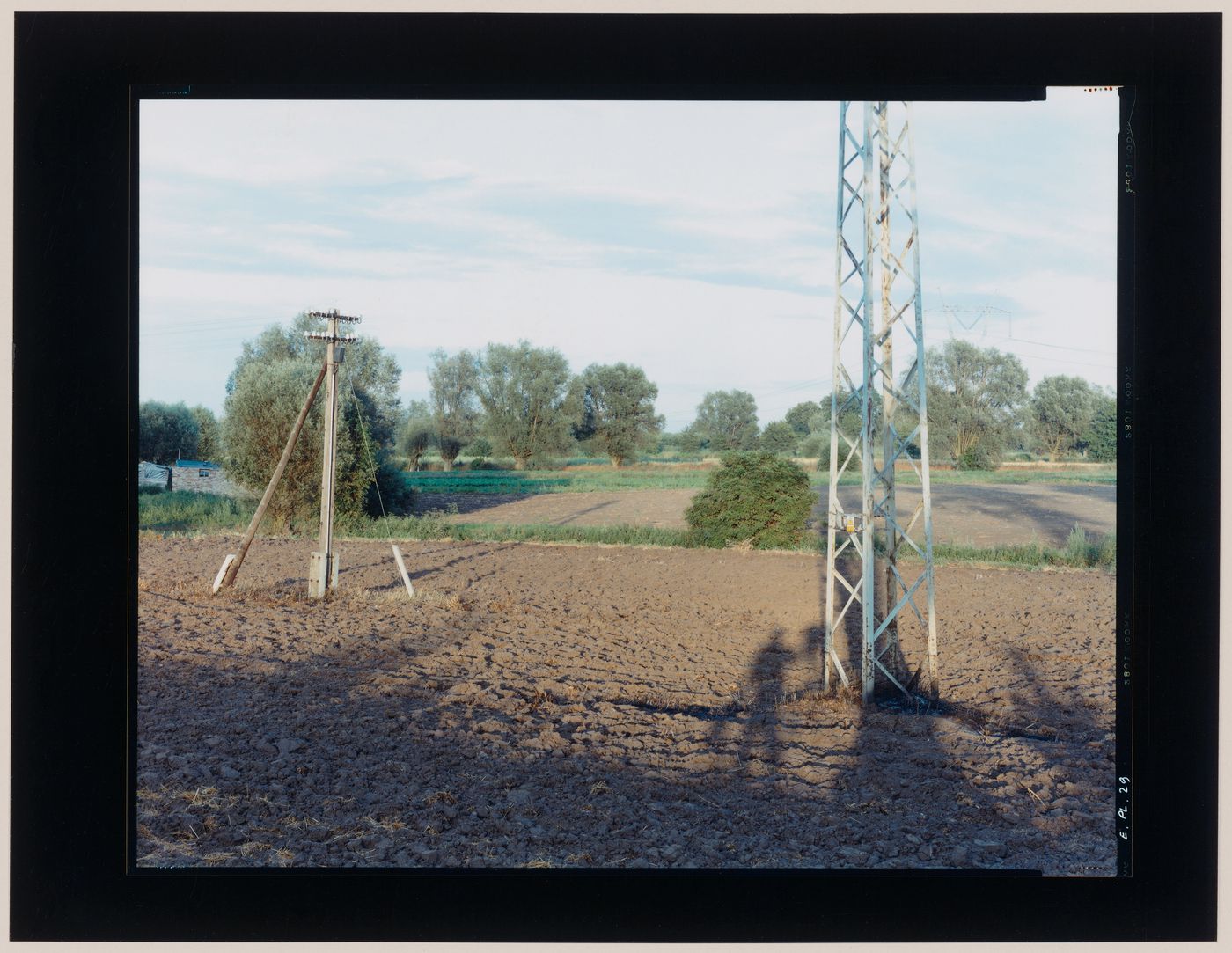 View of agricultural land, a utility pole and an electricity pylon, Gronowo, near Braniewo, Poland (from the series "In between cities")
