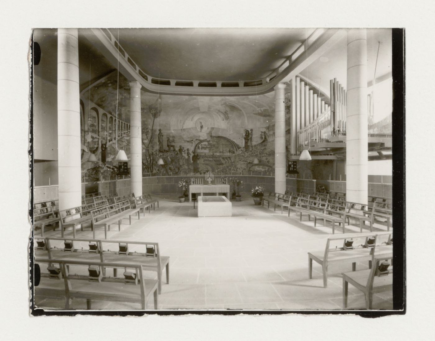 Interior view of the Chapel of the Holy Cross showing the altar, pews and the fresco designed by Sven Erixson, Woodland Crematorium and Cemetery, Stockholm