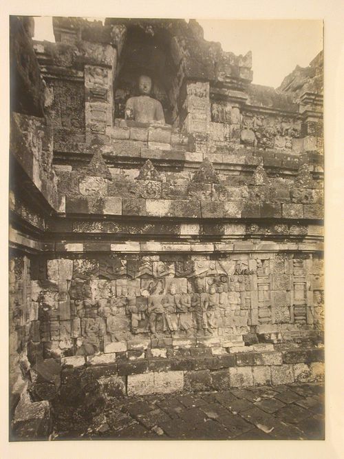 Close-up view of the temple of Borobudur showing relief panels and a statue of the Buddha in a niche, Borobudur, Indonesia