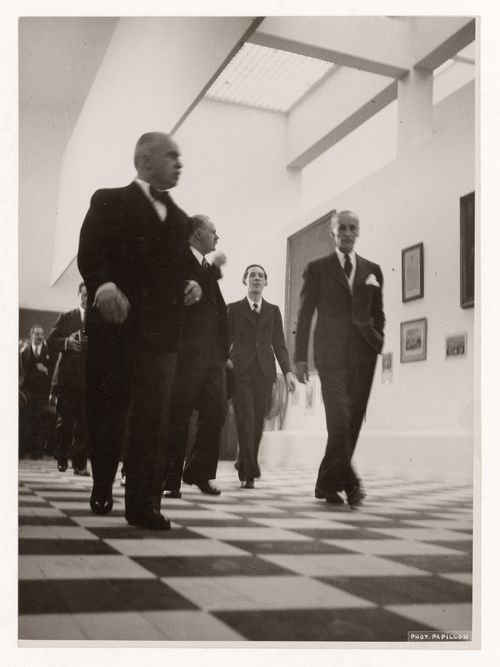 View of Robert Mallet-Stevens guiding visitors in the Solidarité nationale pavillion, Exposition internationale des arts et techniques dans la vie moderne, Paris, France