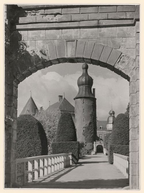 View of Wasserschloss Gemen through an archway and across a bridge, 3 towers visible, Westphalia, Germany