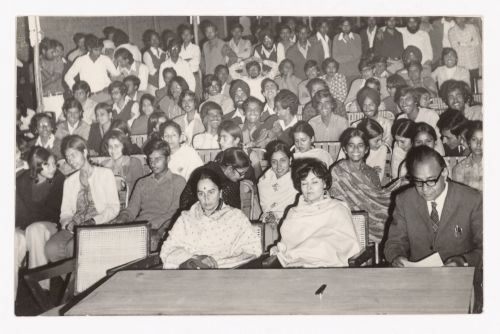 Aditya Prakash, next to Savitri Prakash and Mrs. M.N. Sharma (possibly named Amarit Sharma), and other audience members in the courtyard of the Chandigarh College of Architecture, Chandigarh