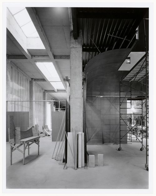 Interior view of the exhibition galleries showing scaffolds and a work table, Canadian Centre for Architecture under construction, Montréal, Québec